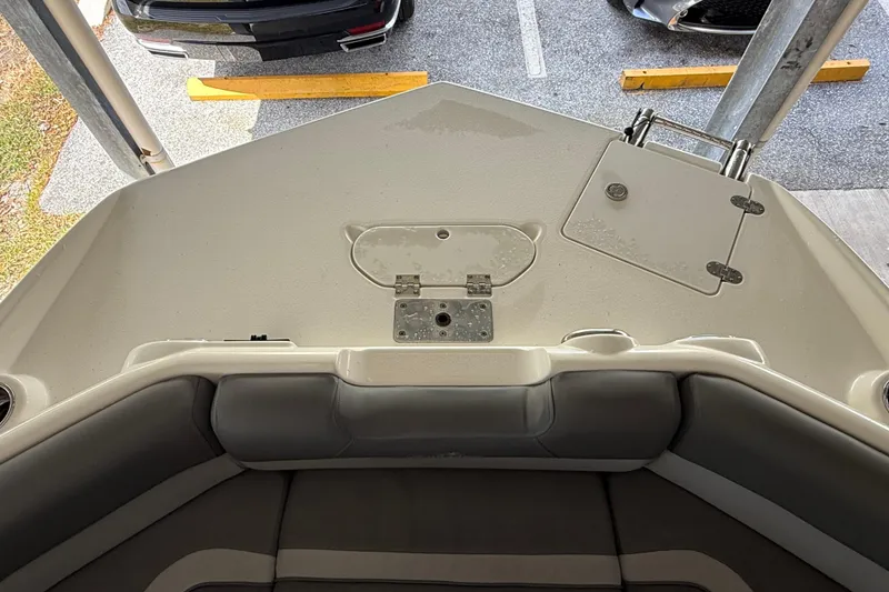 Slide: The Image of 2023 NauticStar 243 DC boat interior, featuring seating and storage compartments. - 54