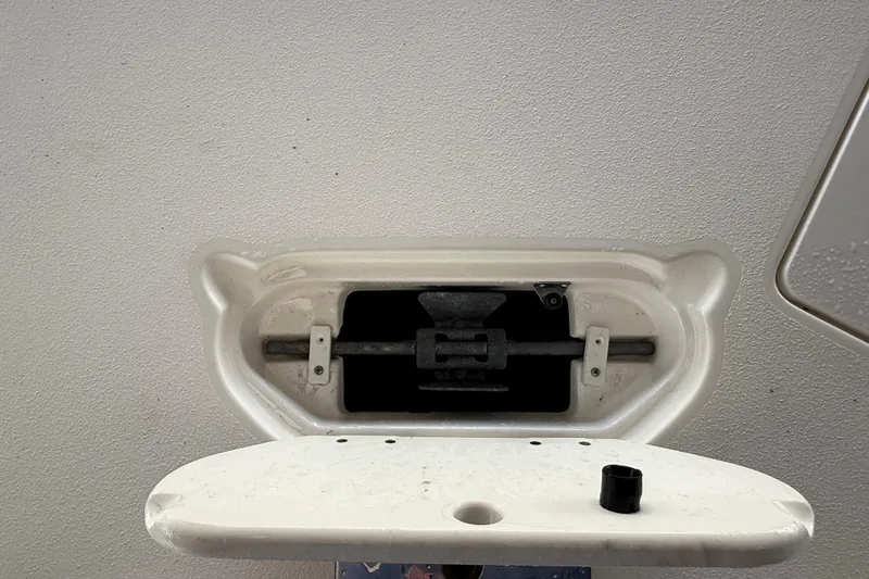 Slide: The Image of 2023 NauticStar 243 DC boat compartment with open hatch and visible hardware. - 55