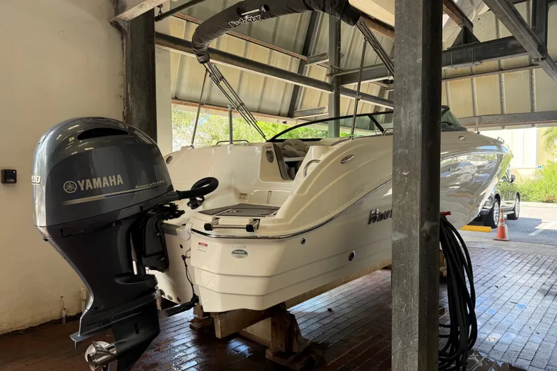 Slide: The Image of 2023 NauticStar 243 DC boat with Yamaha engine in a covered dock. - 7
