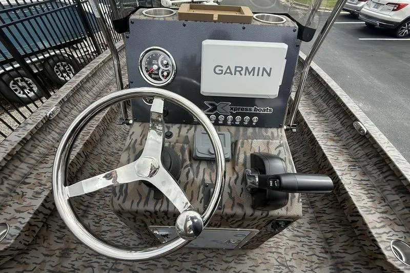 Slide: The Image of 2026 Xpress H22B Bay boat dashboard with Garmin navigation system and steering wheel. - 11