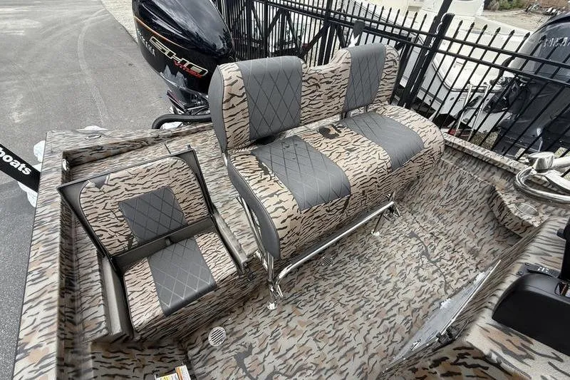 Slide: The Image of 2026 Xpress H22B Bay boat interior with camo-patterned seating and Yamaha outboard motor. - 13