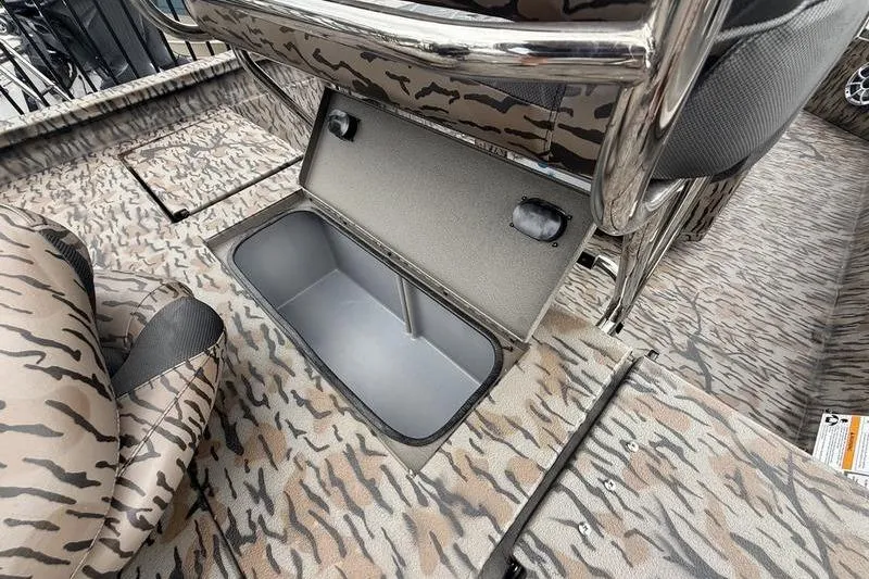 Slide: The Image of 2026 Xpress H22B Bay boat interior with open storage compartment and patterned seating. - 14