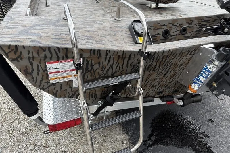 Slide: The Image of 2026 Xpress H22B Bay boat with camouflage pattern and metal ladder. - 16
