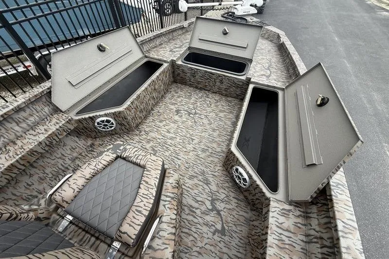 Slide: The Image of 2026 Xpress H22B Bay boat interior with open storage compartments and patterned seating. - 7