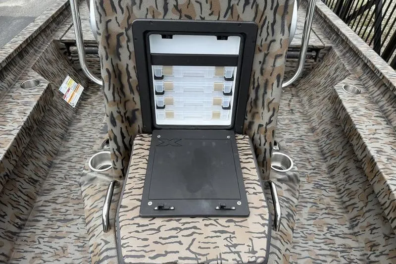 Slide: The Image of 2026 Xpress H22B Bay boat interior with camouflage design and storage compartment. - 8