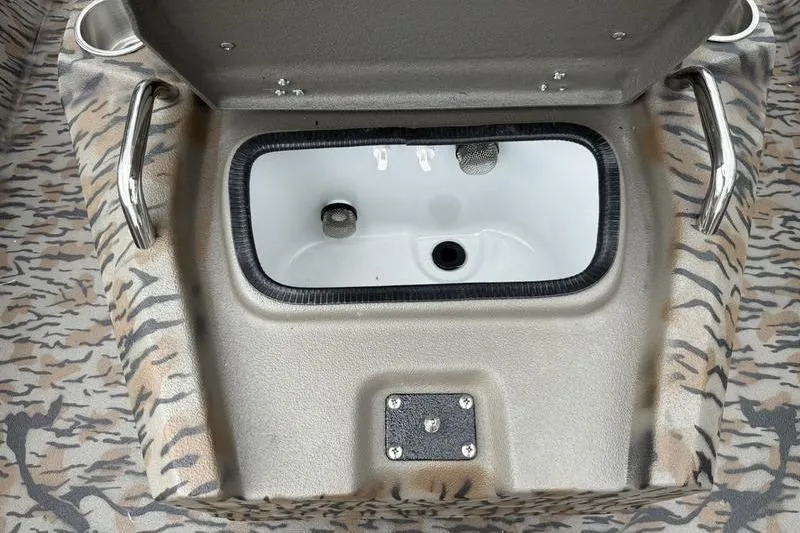 Slide: The Image of 2026 Xpress H22B Bay boat livewell with camo pattern and stainless steel handles. - 9