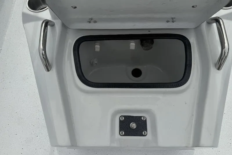 Slide: The Image of Open storage compartment on 2026 Xpress H22B Bay boat with stainless steel handles. - 10