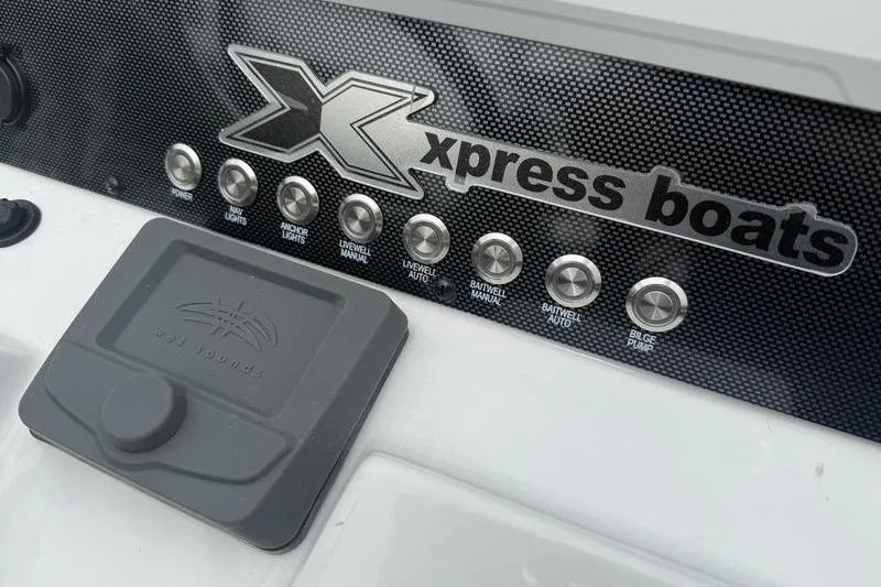 Slide: The Image of Control panel of 2026 Xpress H22B Bay boat with labeled buttons. - 13
