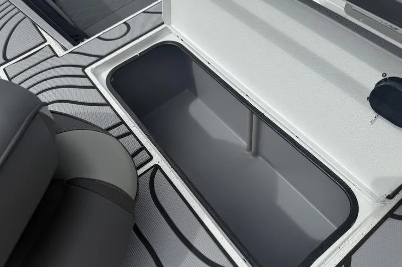 Slide: The Image of Open storage compartment on 2026 Xpress H22B Bay boat with patterned flooring. - 15