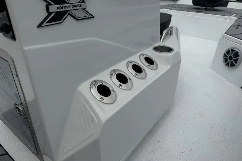 Slide: The Image of 2026 Xpress H22B Bay boat interior with rod holders and speaker. - 16
