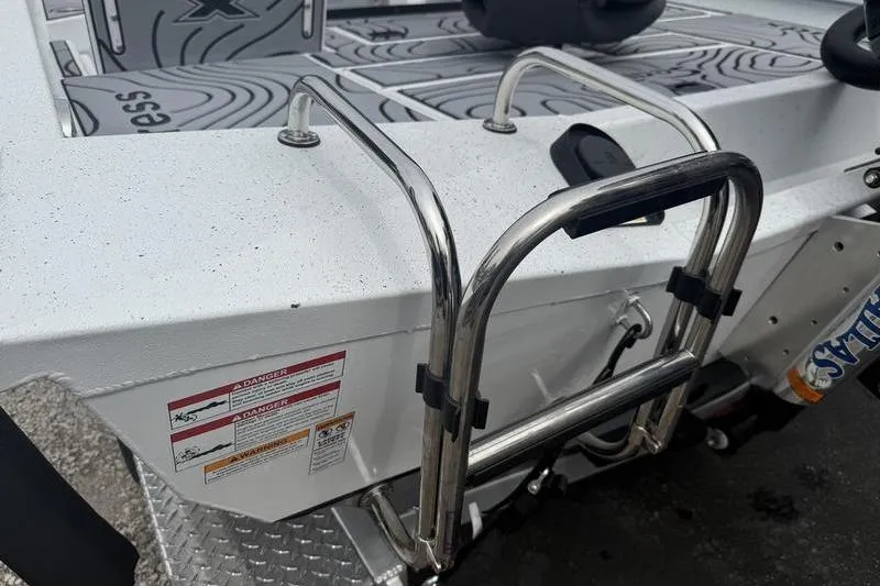 Slide: The Image of 2026 Xpress H22B Bay boat with stainless steel ladder and textured deck. - 19