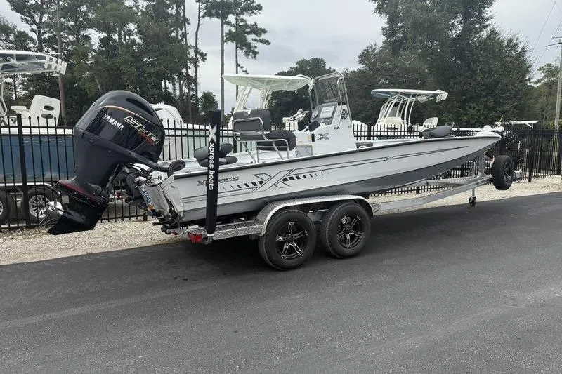 Slide: The Image of 2026 Xpress H22B Bay boat on trailer with Yamaha engine, parked outdoors. - 3