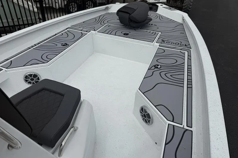 Slide: The Image of 2026 Xpress H22B Bay boat interior with stylish seating and SeaDek flooring. - 5