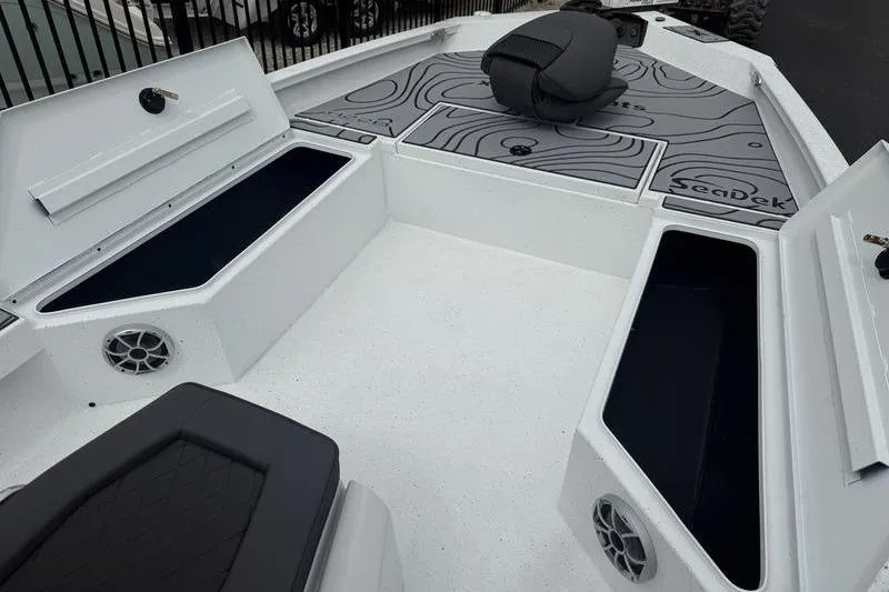 Slide: The Image of 2026 Xpress H22B Bay boat interior with storage compartments and seating. - 6