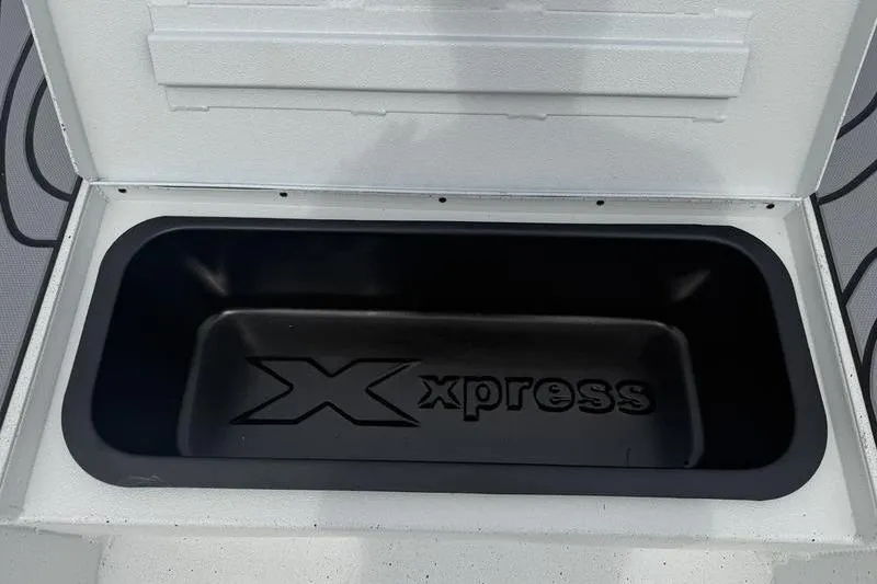 Slide: The Image of Open storage compartment in 2026 Xpress H22B Bay boat. - 7