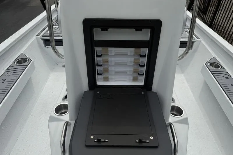 Slide: The Image of 2026 Xpress H22B Bay boat interior with storage compartments and cup holders. - 9