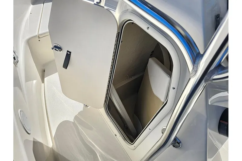 Slide: The Image of 2019 Bulls Bay 200 CC boat storage compartment with open door, showcasing interior space. - 13