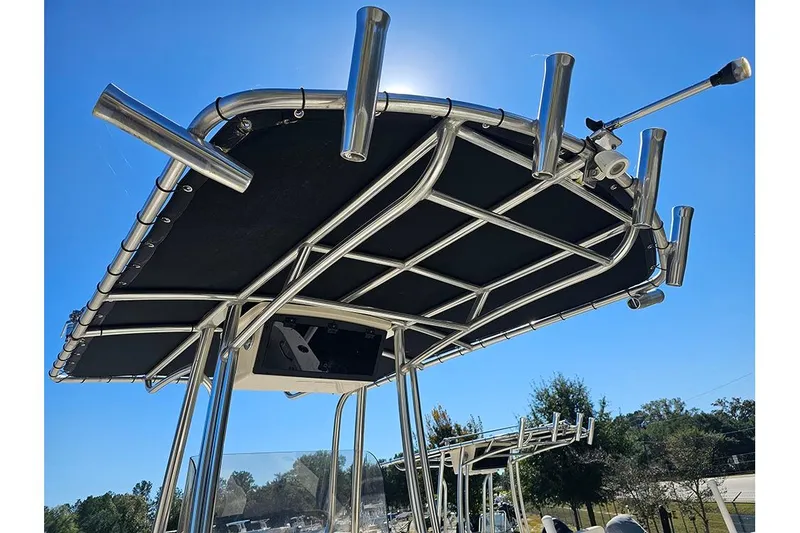 Slide: The Image of 2019 Bulls Bay 200 CC boat T-top with rod holders under clear blue sky. - 16