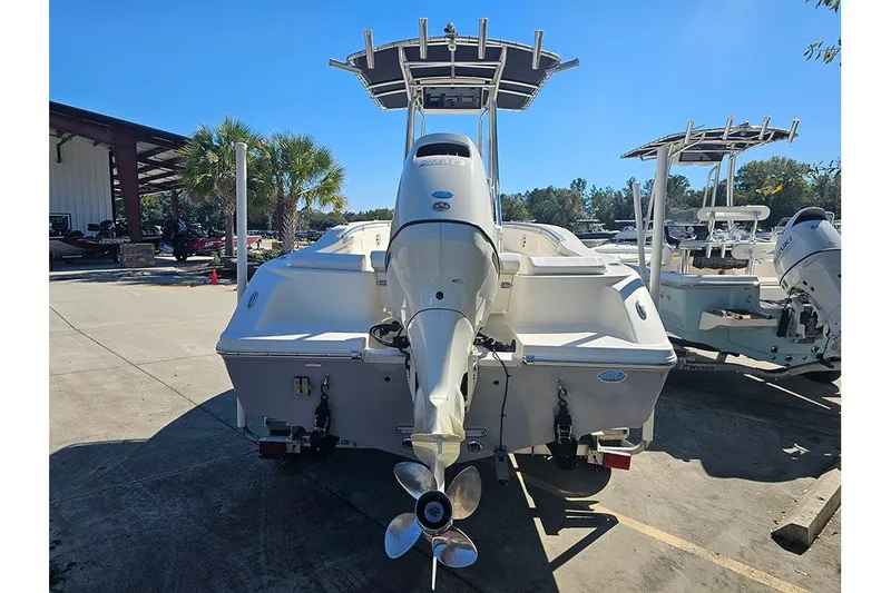 Slide: The Image of 2019 Bulls Bay 200 CC boat with outboard motor, parked outdoors. - 7