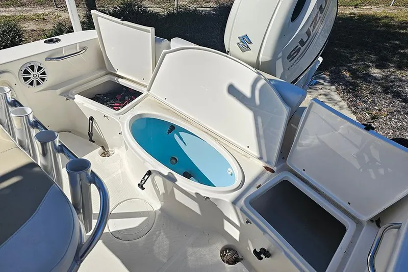 Slide: The Image of 2019 Bulls Bay 200 CC boat interior with open storage compartments and Suzuki engine. - 9