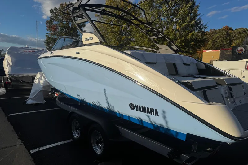 Slide: The Image of 2026 Yamaha Boats 252SD in parking lot, sleek design, blue and white exterior. - 10