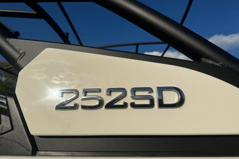 Slide: The Image of Close-up of 2026 Yamaha Boats 252SD model emblem against a clear blue sky. - 11