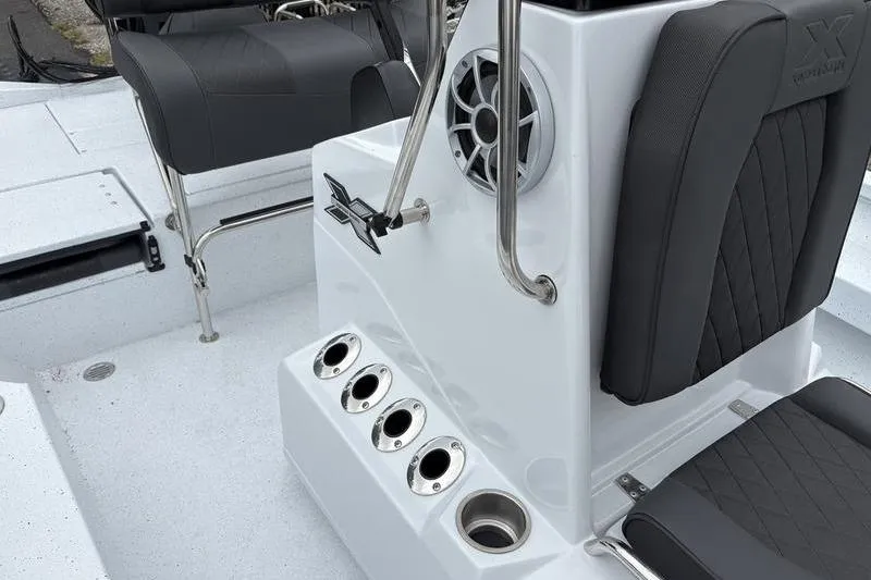 Slide: The Image of 2026 Xpress H20B Bay boat interior with seating, speaker, and rod holders. - 10