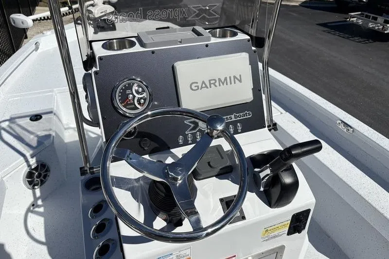 Slide: The Image of 2026 Xpress H20B Bay boat dashboard with Garmin navigation system and steering wheel. - 11
