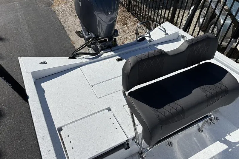 Slide: The Image of 2026 Xpress H20B Bay boat with black seating and outboard motor. - 13