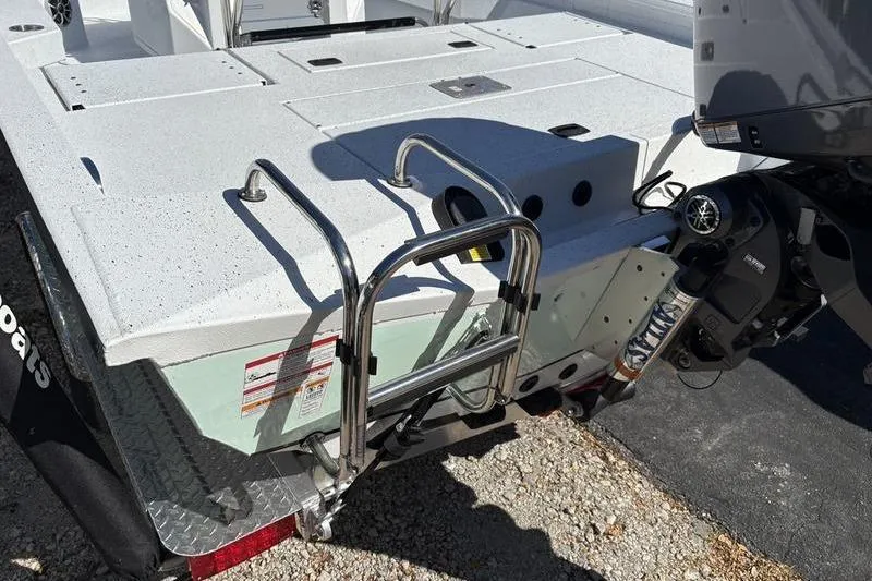 Slide: The Image of 2026 Xpress H20B Bay boat with motor and ladder on trailer. - 16