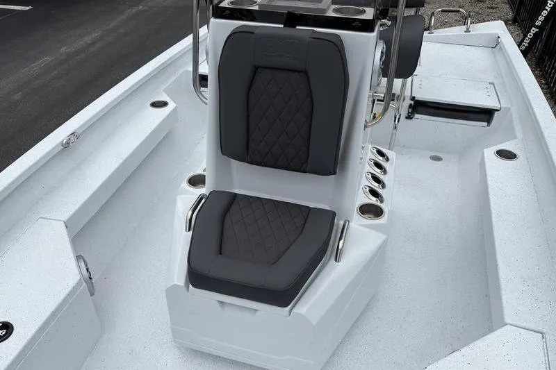 Slide: The Image of 2026 Xpress H20B Bay boat interior with cushioned seating and rod holders. - 7