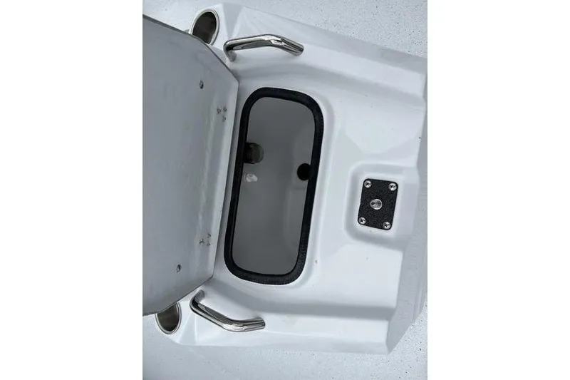 Slide: The Image of Open storage compartment on 2026 Xpress H20B Bay boat, featuring stainless steel handles. - 9