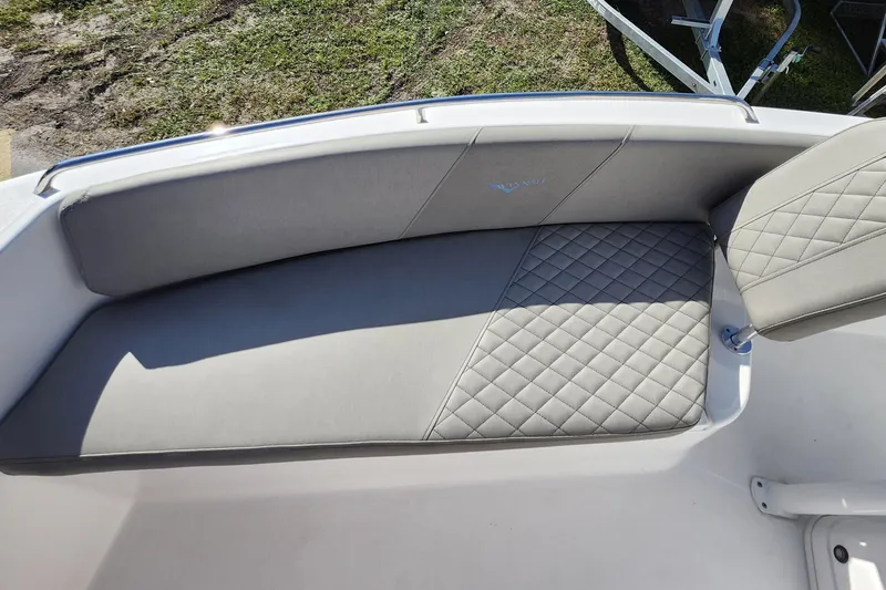 Slide: The Image of 2025 Savannah 2200 Offshore boat with quilted gray seating and sleek design. - 13