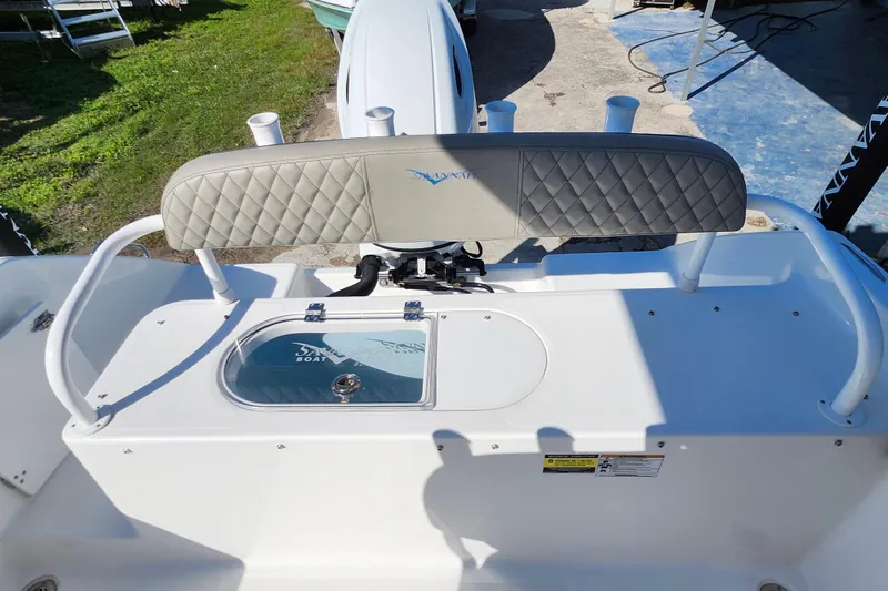 Slide: The Image of 2025 Savannah 2200 Offshore boat interior with cushioned seating and storage compartment. - 24