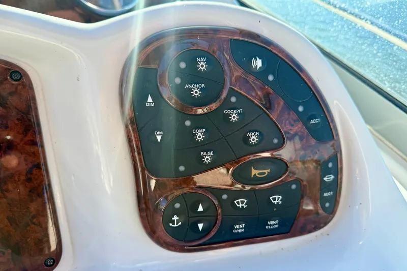 Slide: The Image of Control panel of a 2004 Sea Ray 320 Sundancer boat with various function buttons. - 16