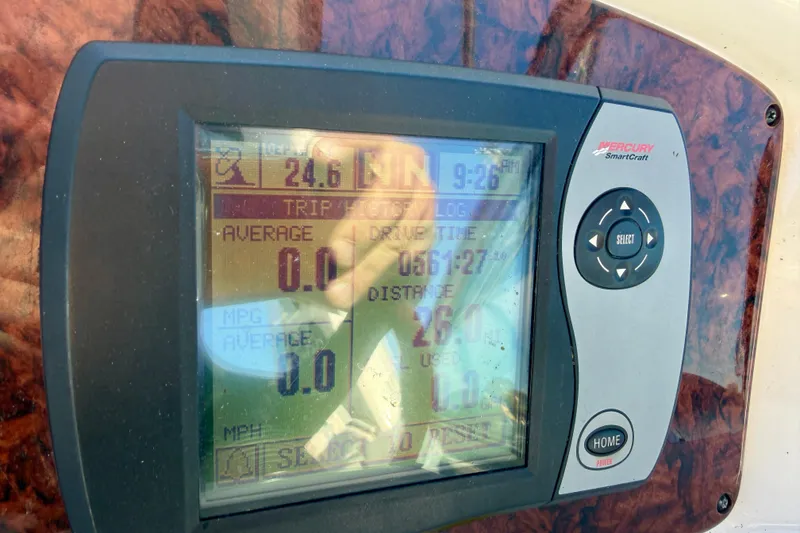 Slide: The Image of Mercury SmartCraft display on 2004 Sea Ray 320 Sundancer showing trip data and controls. - 18