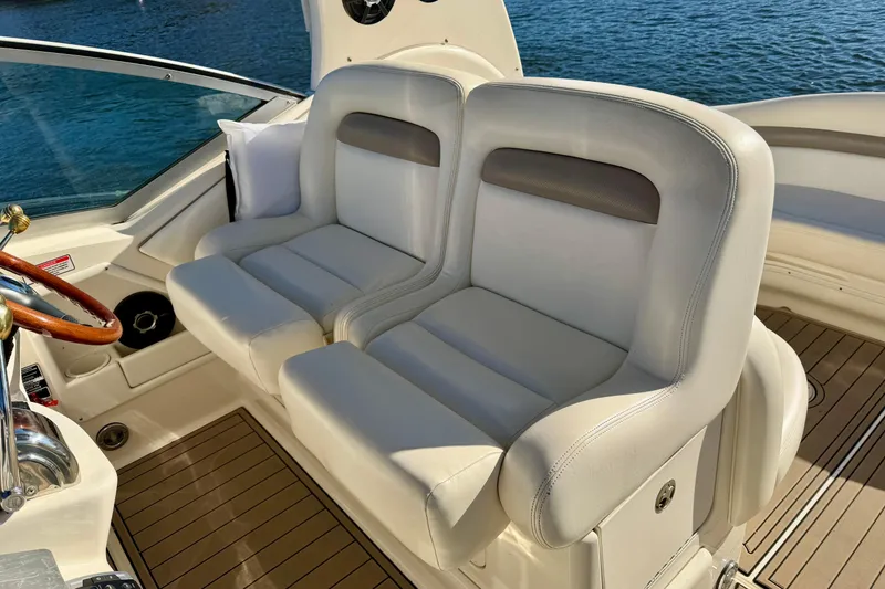 Slide: The Image of Luxury seating on 2004 Sea Ray 320 Sundancer boat, featuring elegant white upholstery. - 21