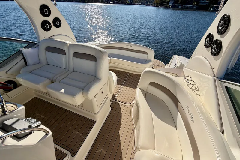 Slide: The Image of Luxurious 2004 Sea Ray 320 Sundancer boat interior with plush seating on a sunny day. - 26