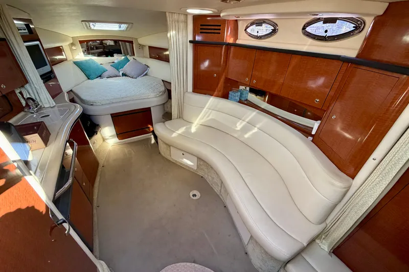 Slide: The Image of Luxurious interior of 2004 Sea Ray 320 Sundancer with plush seating and cozy sleeping area. - 29