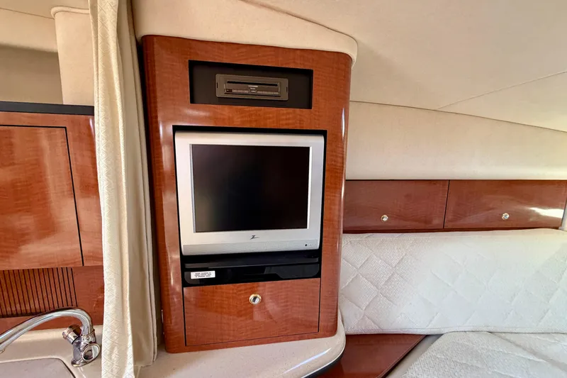 Slide: The Image of 2004 Sea Ray 320 Sundancer cabin with built-in TV and DVD player. - 32