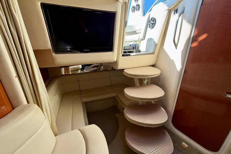 Slide: The Image of Interior of 2004 Sea Ray 320 Sundancer with TV, curved seating, and spiral stairs. - 37