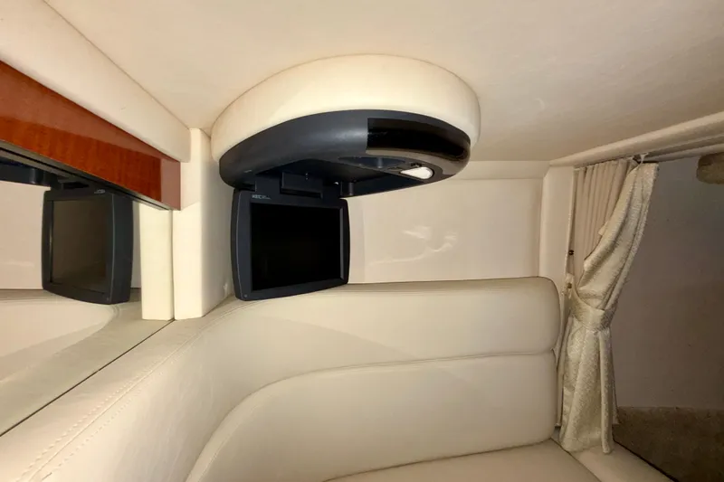 Slide: The Image of 2004 Sea Ray 320 Sundancer cabin interior with TV and beige seating. - 39