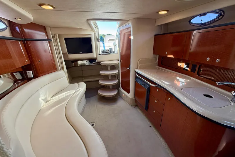 Slide: The Image of Luxurious interior of 2004 Sea Ray 320 Sundancer yacht with elegant seating and kitchenette. - 40