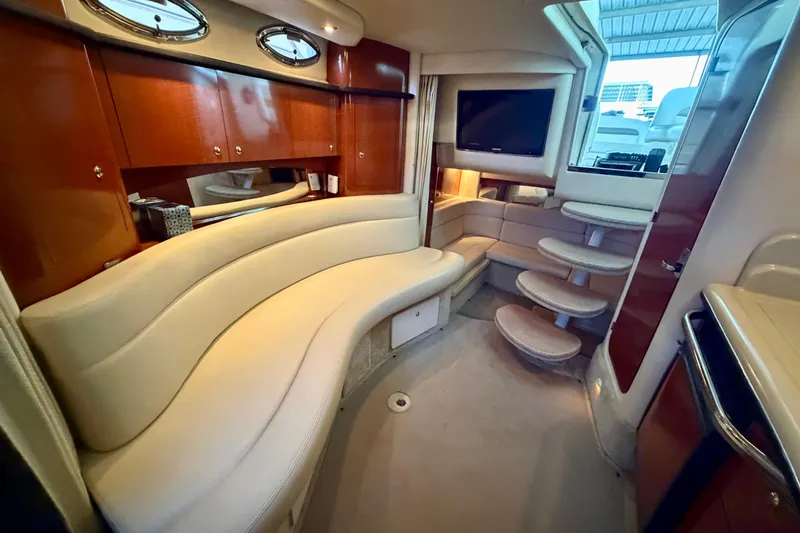Slide: The Image of Luxurious interior of 2004 Sea Ray 320 Sundancer yacht with curved seating and TV. - 41