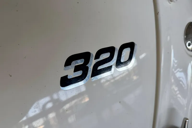 Slide: The Image of Close-up of 2004 Sea Ray 320 Sundancer model number on boat exterior. - 43