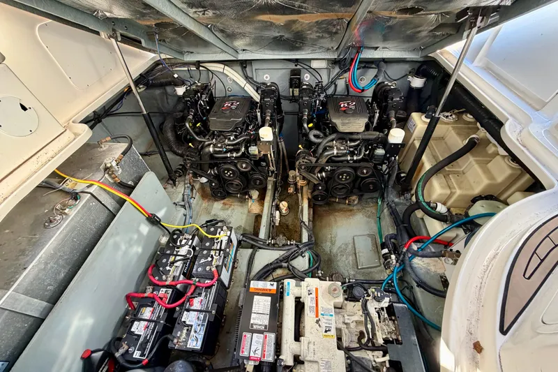 Slide: The Image of Engine compartment of a 2004 Sea Ray 320 Sundancer with dual engines and batteries. - 44