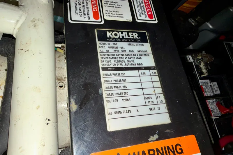 Slide: The Image of Kohler generator label on 2004 Sea Ray 320 Sundancer, showing specifications and warnings. - 48