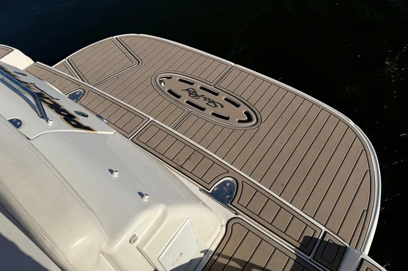 Slide: The Image of 2004 Sea Ray 320 Sundancer swim platform with custom decking, docked on calm water. - 8