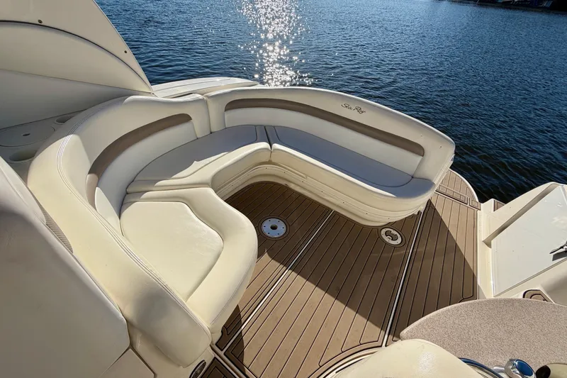 Slide: The Image of Luxurious seating on 2004 Sea Ray 320 Sundancer yacht, overlooking serene water. - 9