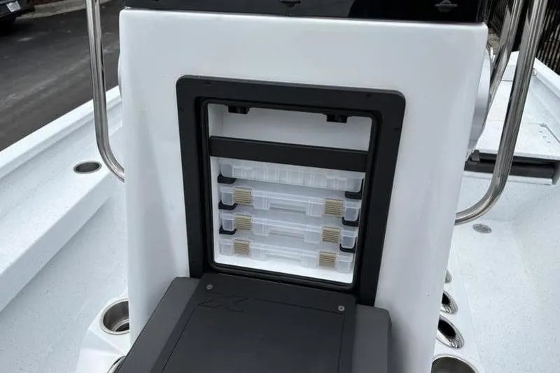 Slide: The Image of 2026 Xpress H20B Bay boat with tackle storage compartment and rod holders. - 10
